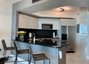 Modern kitchen with granite countertops and stainless steel appliances.